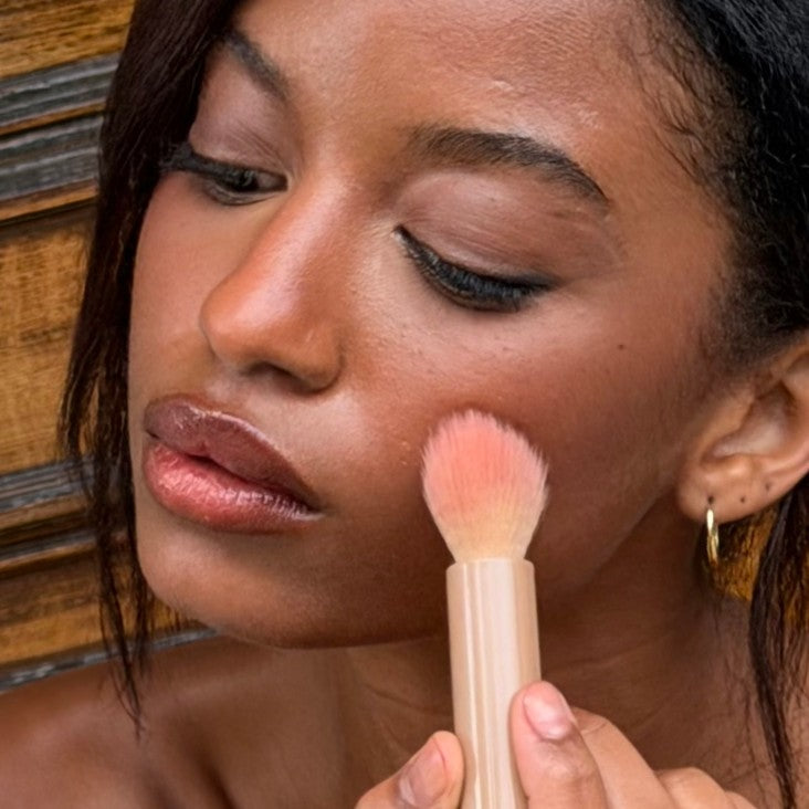 Applying blush with a makeup brush
